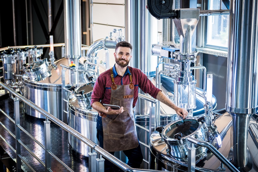 brewery owner inspecting mash tun