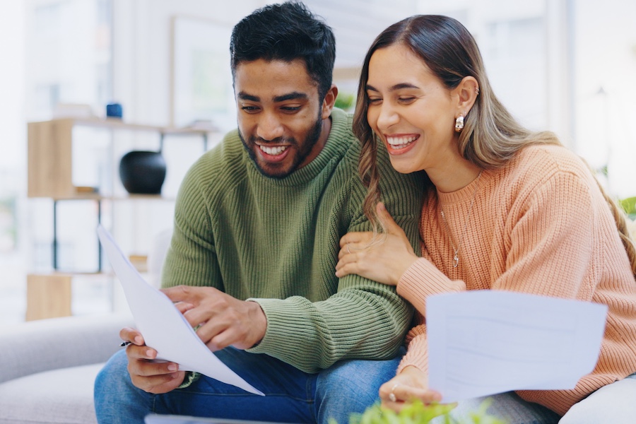 couple happily reviewing investment statements